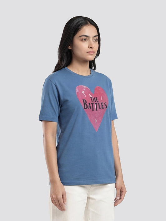 Woman wearing a blue t-shirt with a pink heart graphic and text on a light gray background