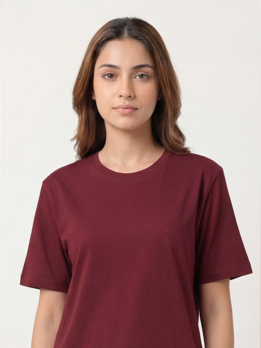 Woman wearing a maroon t-shirt against a plain background