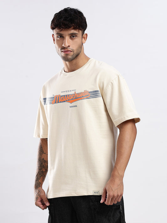 Man wearing a beige t-shirt with a print on it