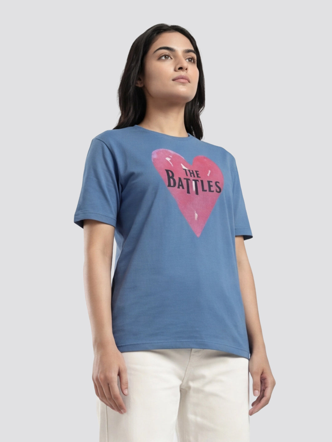 Woman wearing a blue t-shirt with a pink heart design and text on a light gray background