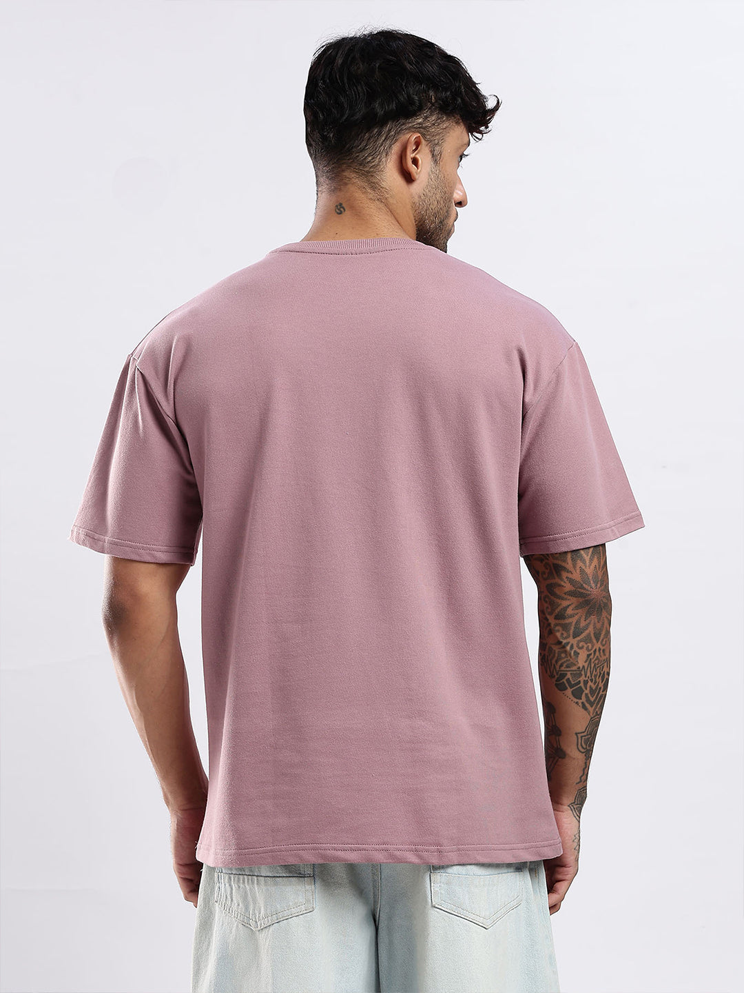 Person wearing a pink t-shirt on a white background