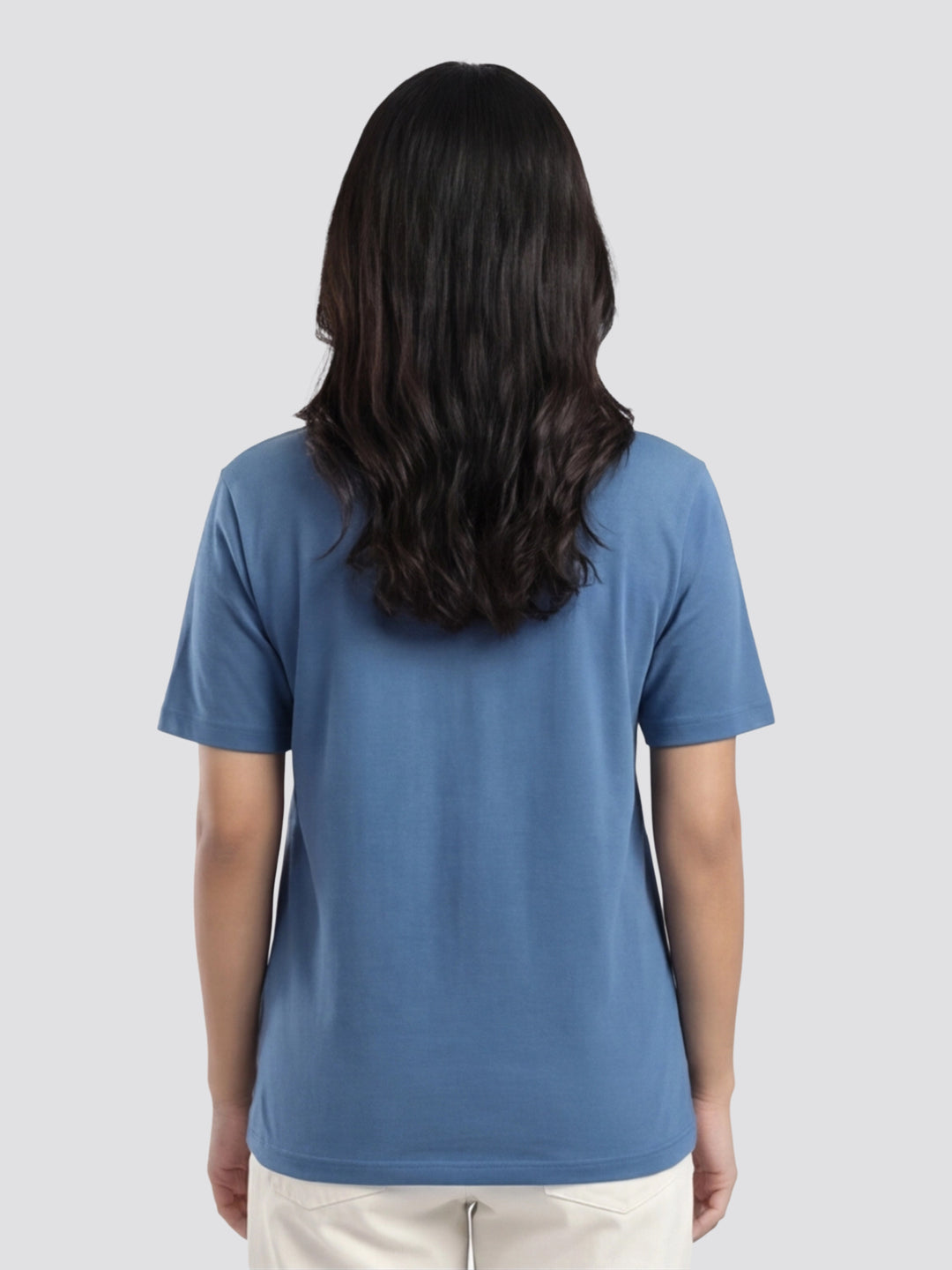 Person wearing a blue t-shirt on a plain background