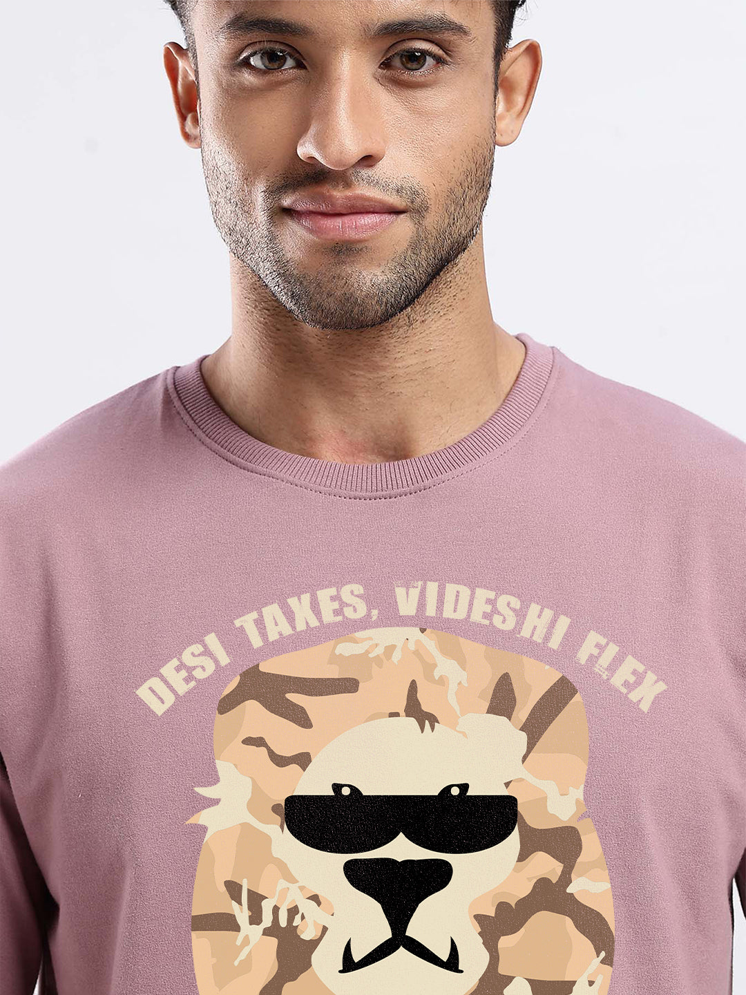 Man wearing a pink sweatshirt with a graphic design and text on a light gray background