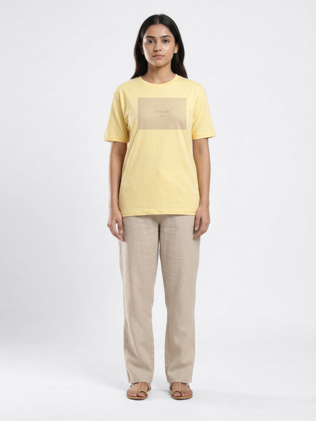 Woman wearing a yellow t-shirt with a square design on a white background