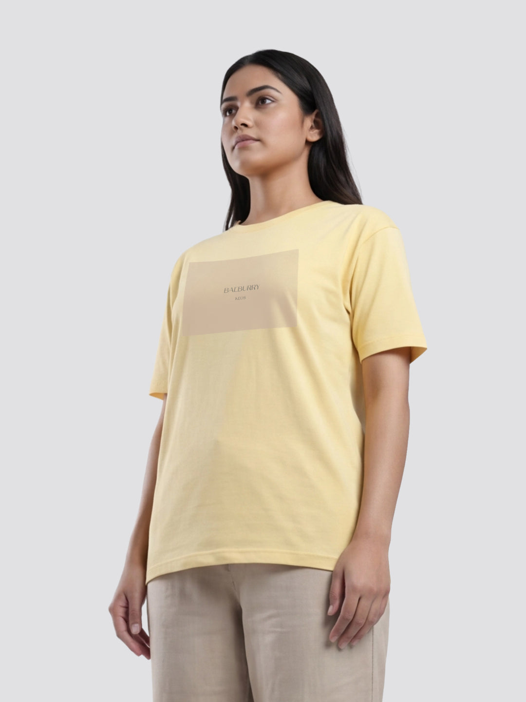 Woman wearing a yellow t-shirt with text on a plain background