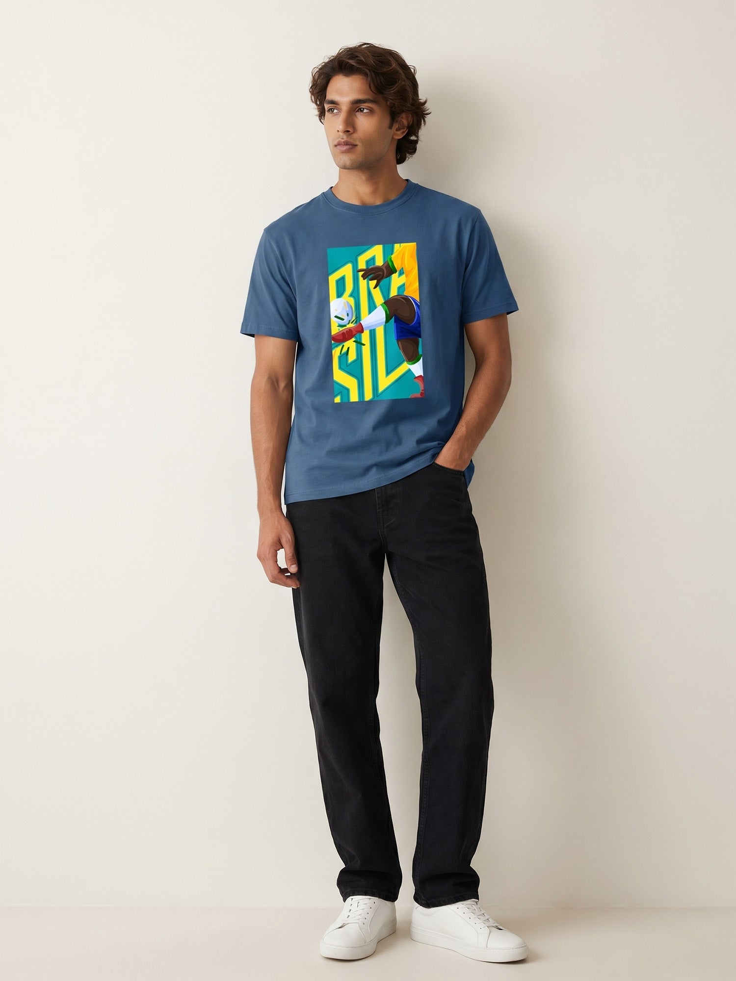 Man wearing a blue t-shirt with a colorful graphic design of Brasil on a plain background