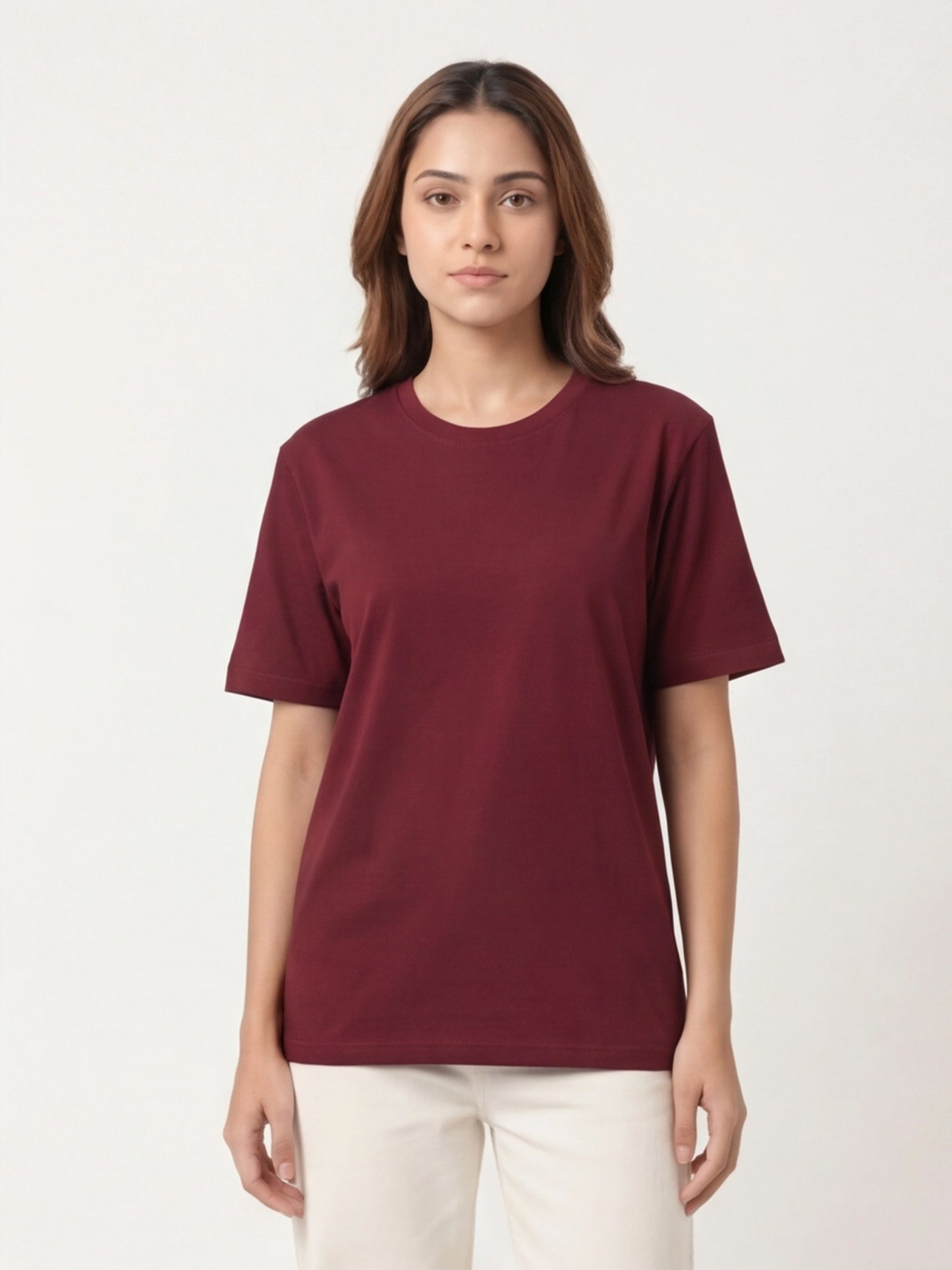 Woman wearing a maroon t-shirt against a white background