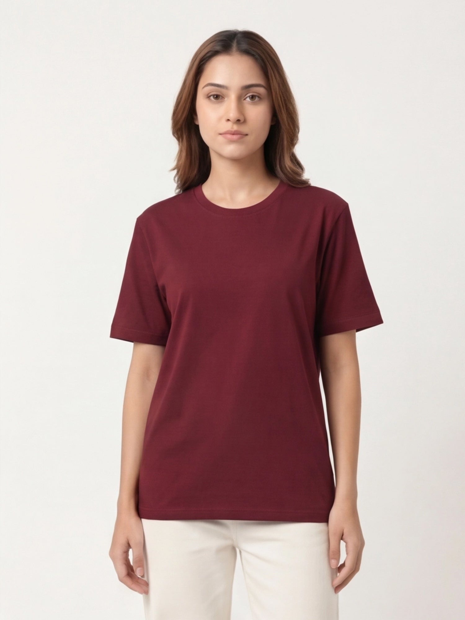Woman wearing a maroon t-shirt against a white background