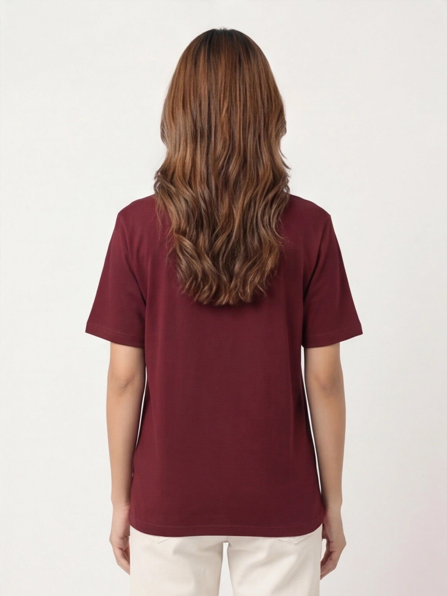Person wearing a maroon t-shirt on a white background