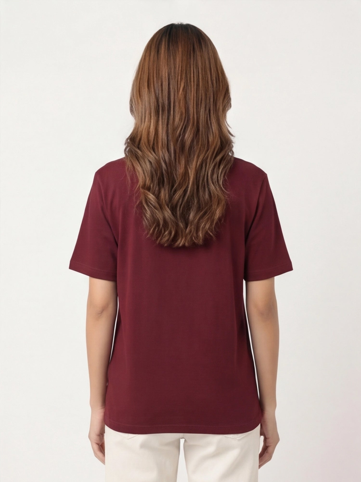 Person wearing a maroon t-shirt on a white background