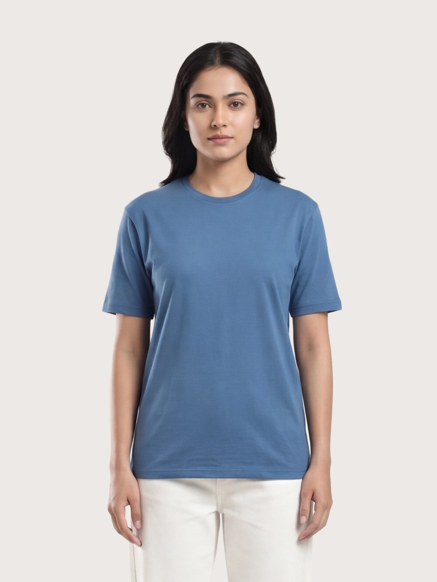 Woman wearing a blue t-shirt against a plain background
