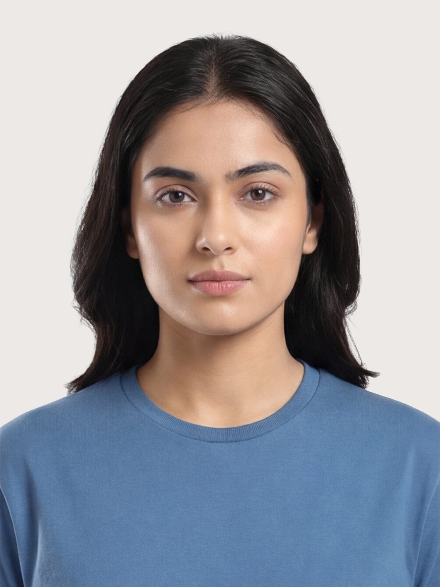 Woman wearing a blue shirt against a plain background