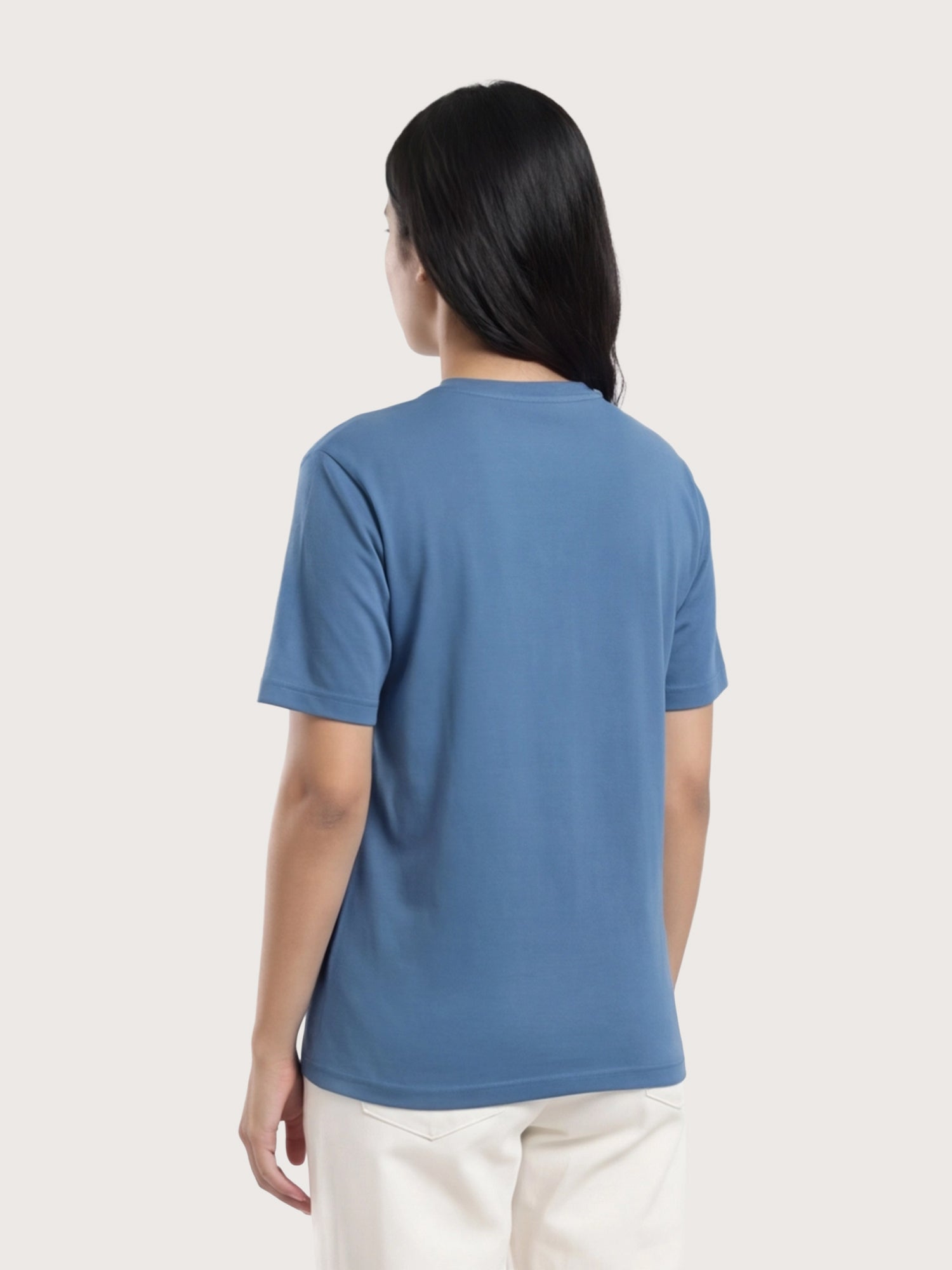 Person wearing a blue t-shirt on a plain background