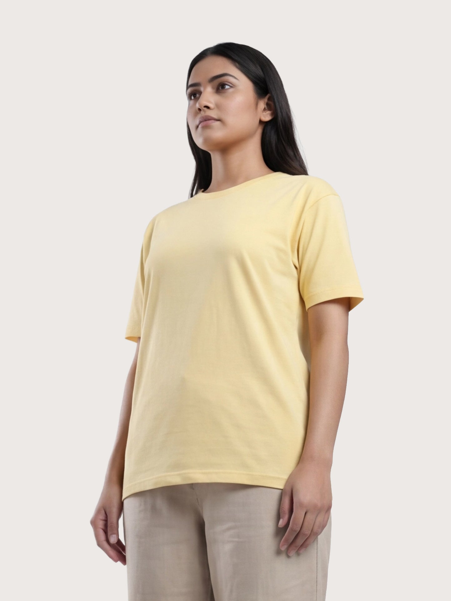 Woman wearing a yellow t-shirt against a white background