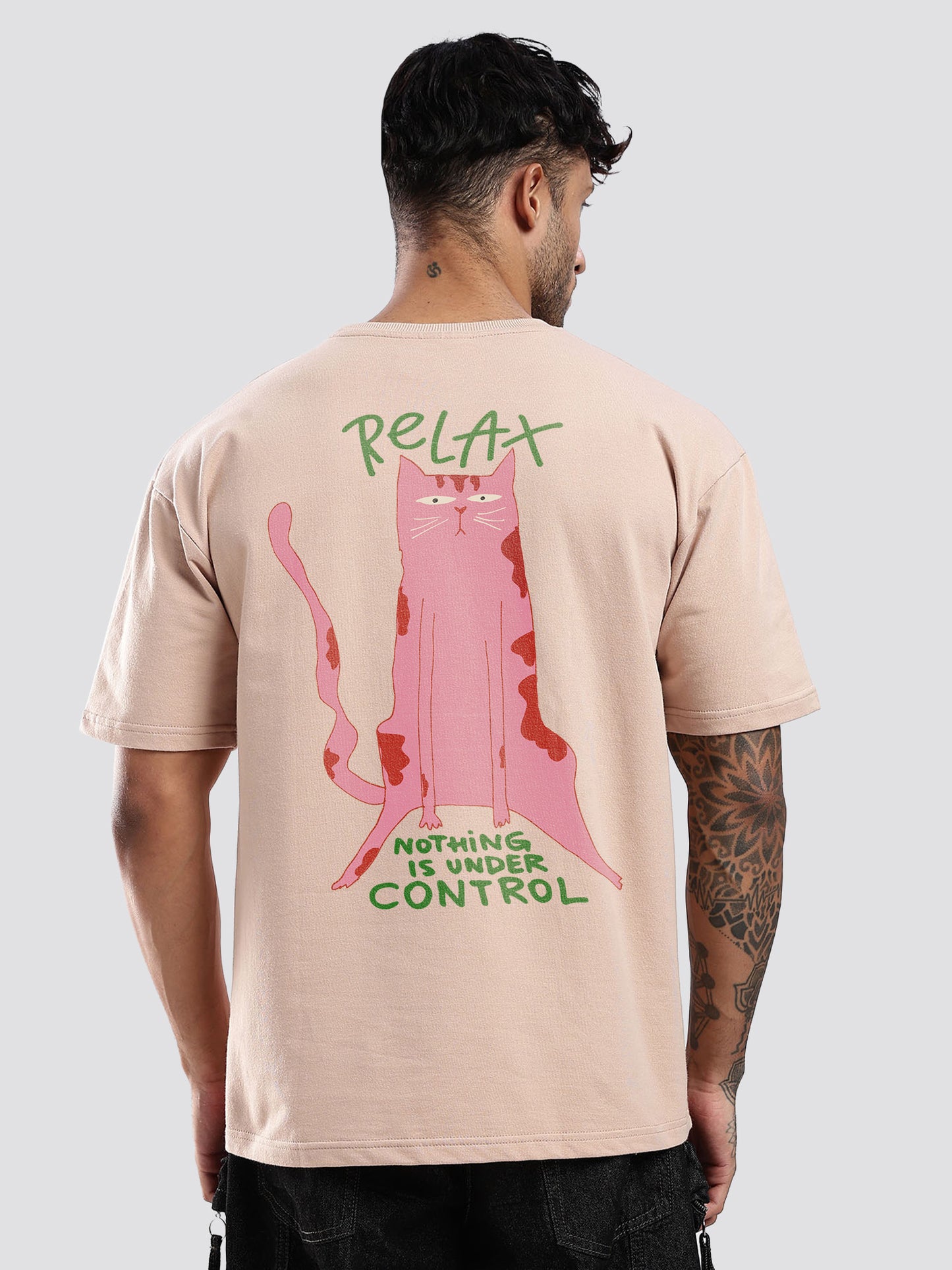 Person wearing a beige t-shirt with a pink cat graphic and text on the back.