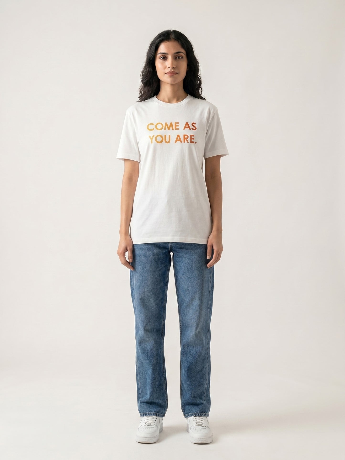 Keos Come As You Are white cotton graphic t-shirt for women, featuring bold Pride Month statement text with blue jeans and white sneakers.