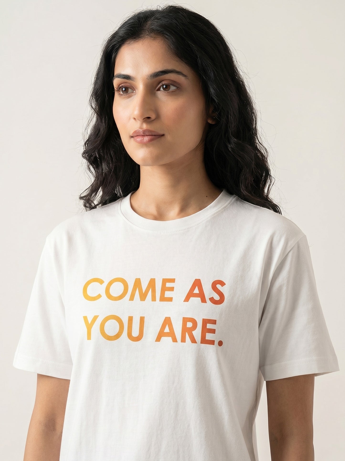 Close-up of Keos Come As You Are white cotton t-shirt showing yellow orange statement print, crew neck, half sleeves, and soft fabric texture.