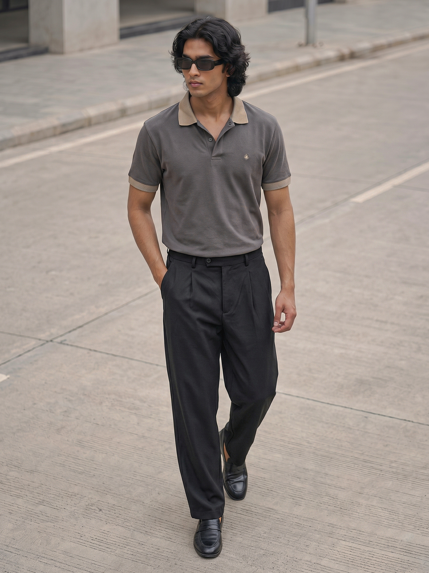 Charcoal Grey Polo Shirt Keos premium cotton polo shirt in charcoal grey with contrast collar, paired with tailored black pleated trousers and loafers. Modern men’s fashion inspired by quiet luxury, old money dressing, smart casual menswear, luxury essentials and contemporary style.
