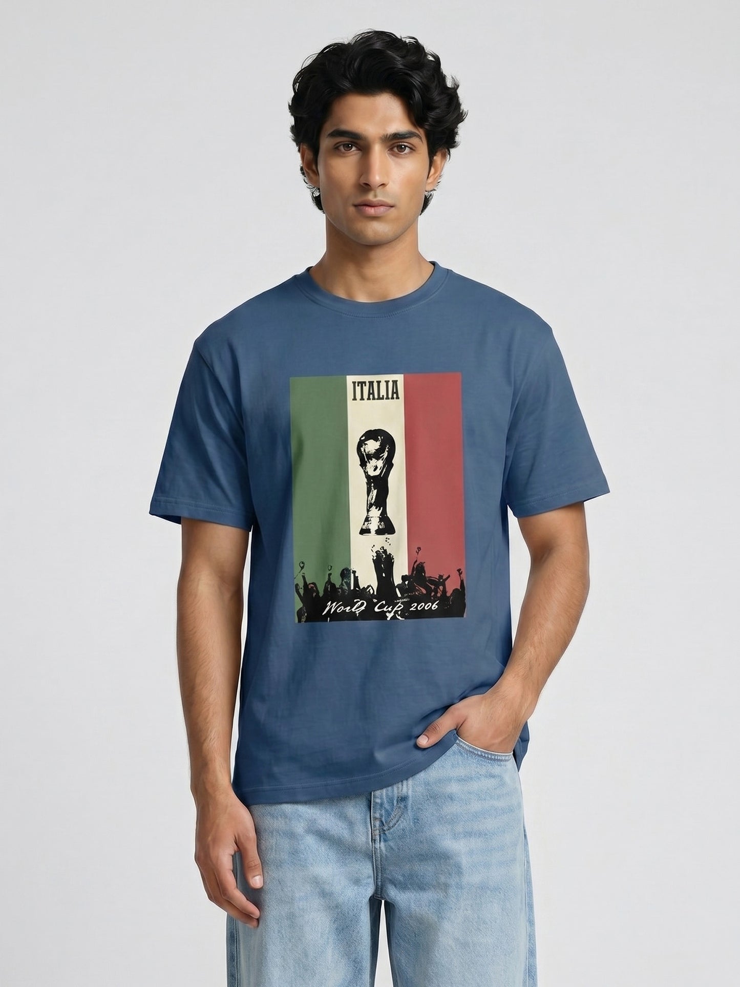Man wearing a blue t-shirt with a graphic design written Italia and world cup on a light grey background