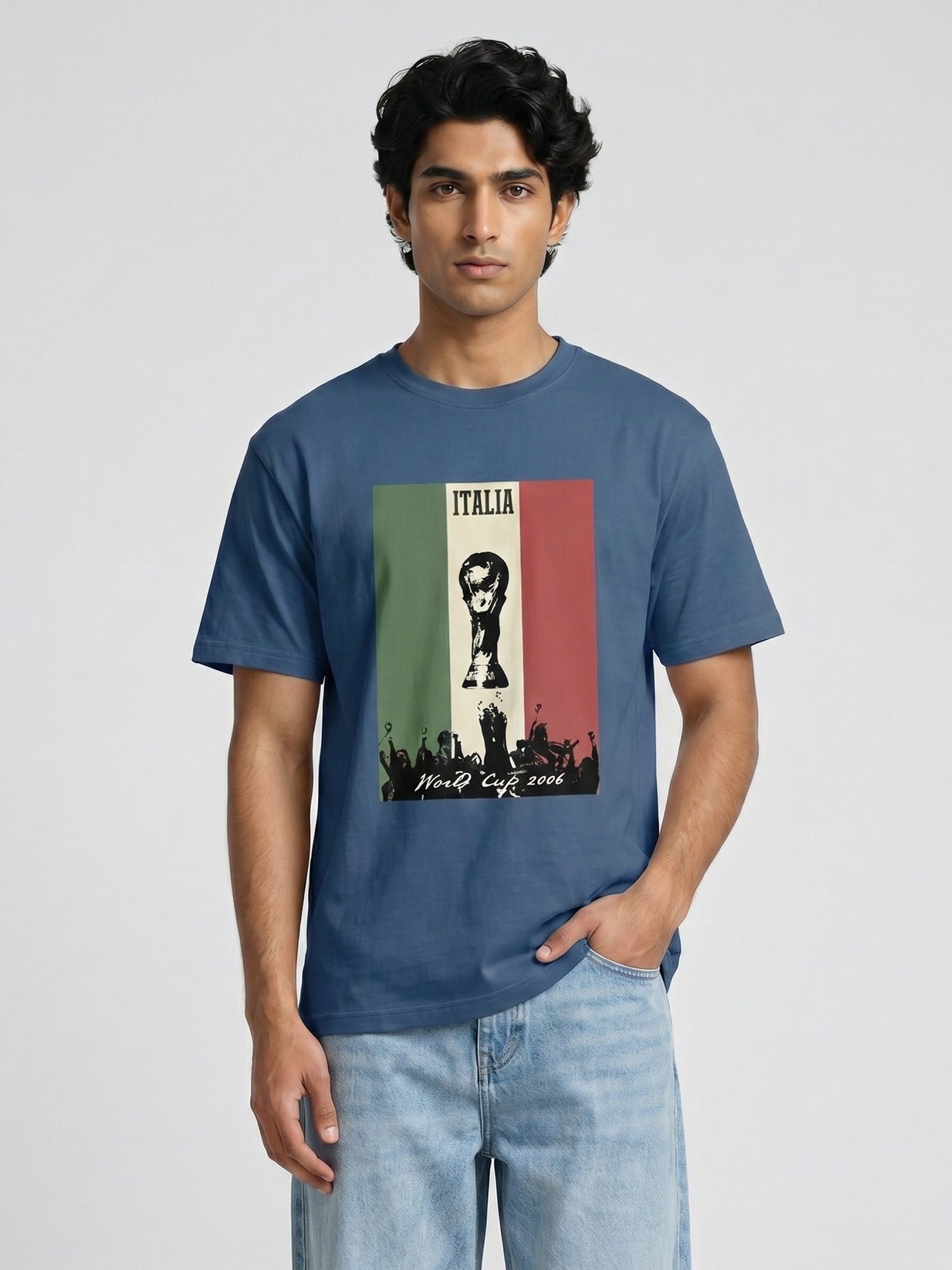 Man wearing a blue t-shirt with a graphic design written Italia and world cup on a light grey background