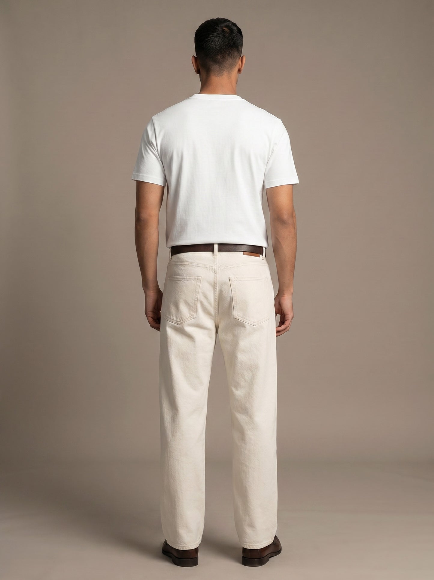 Back view of white Keos cotton t-shirt styled with off-white denim, showing clean regular fit and minimal everyday menswear look.
