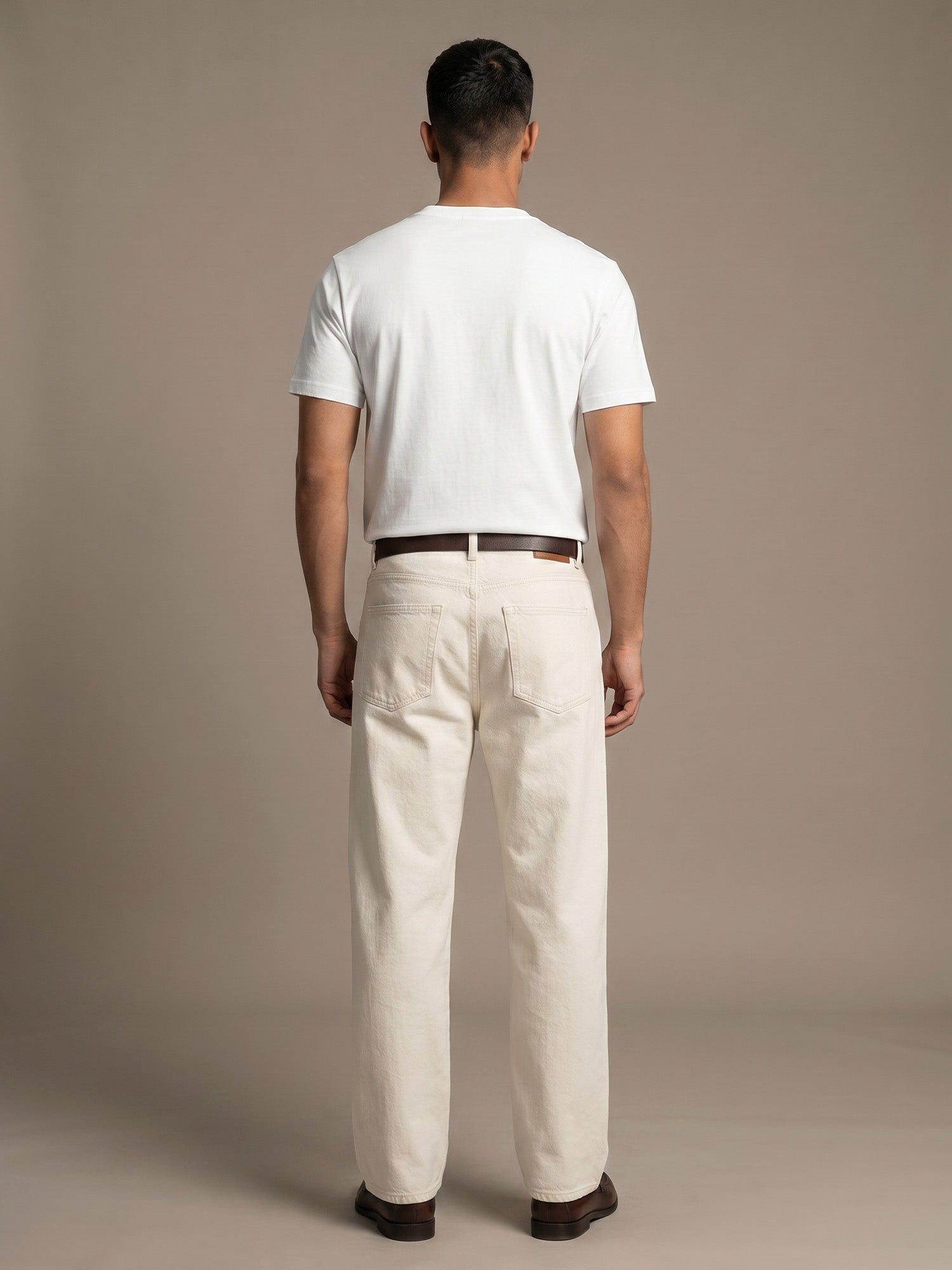 Back view of white Keos cotton t-shirt styled with off-white denim, showing clean regular fit and minimal everyday menswear look.