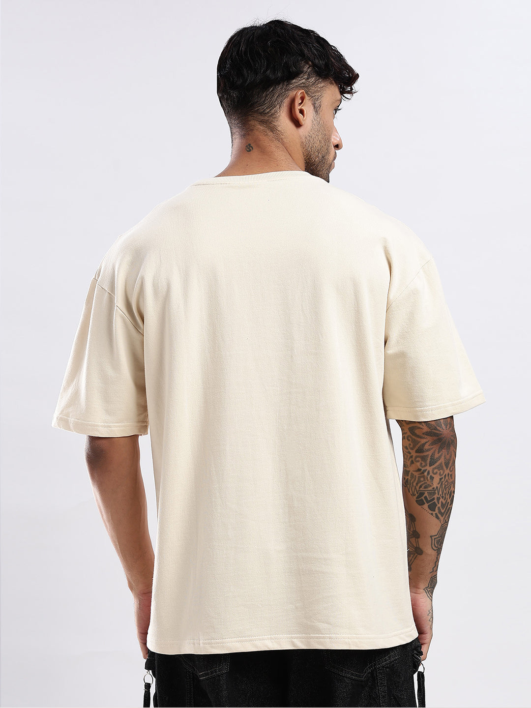 Man wearing a beige t-shirt on a white background