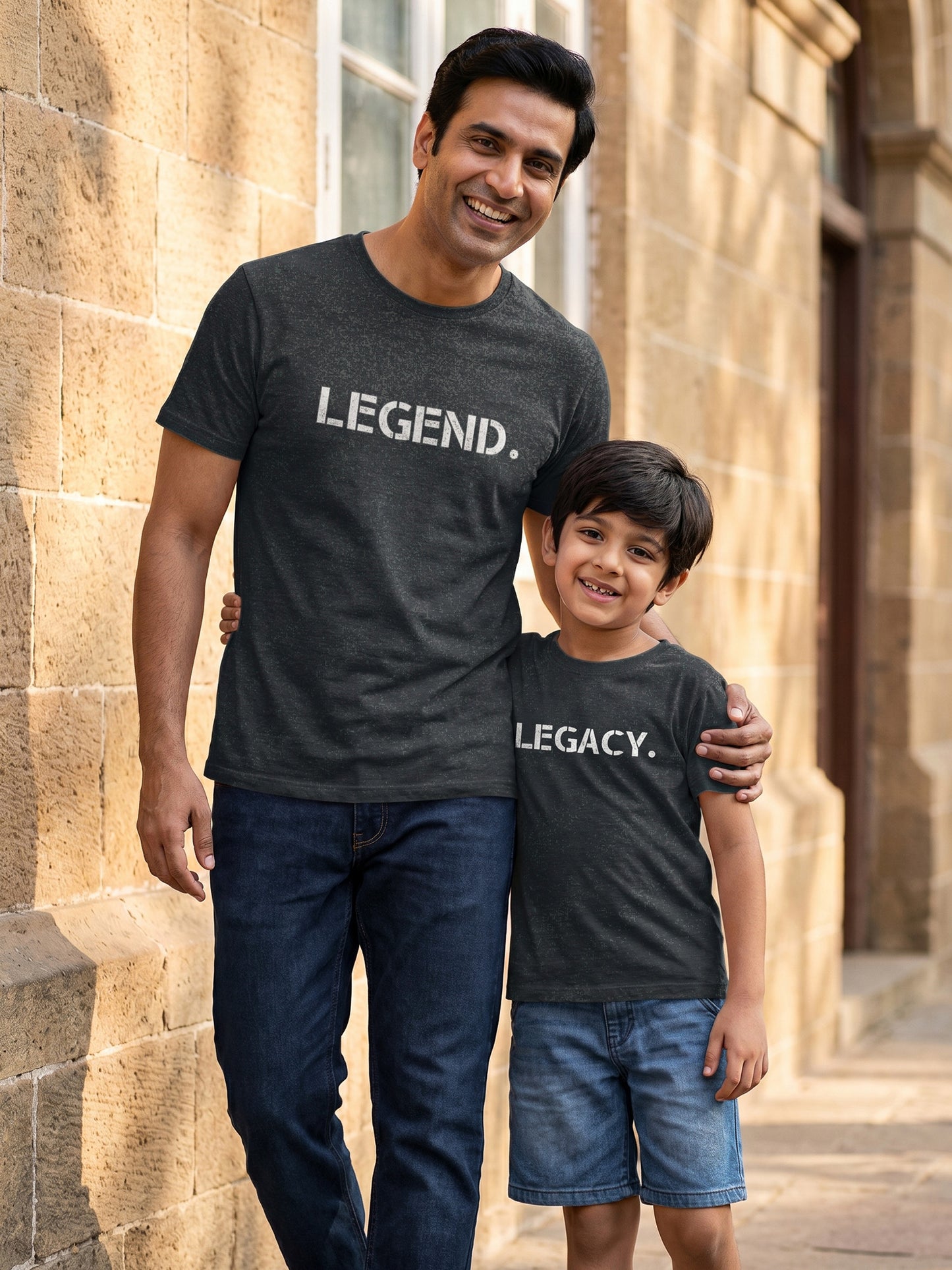 Matching t-shirts with 'LEGEND.' and 'LEGACY.' text, standing in front of a stone building.