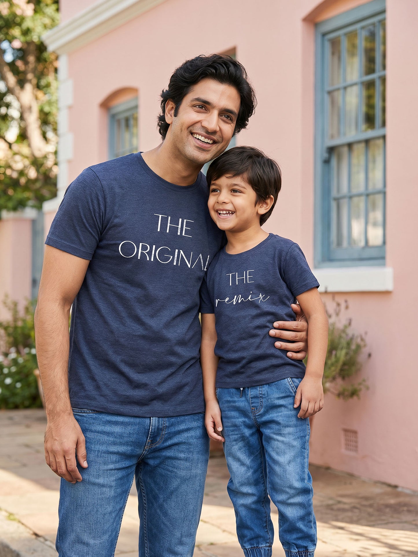 Father and child wearing matching navy blue t-shirts 