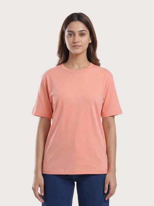 Woman wearing a peach-colored t-shirt against a white background