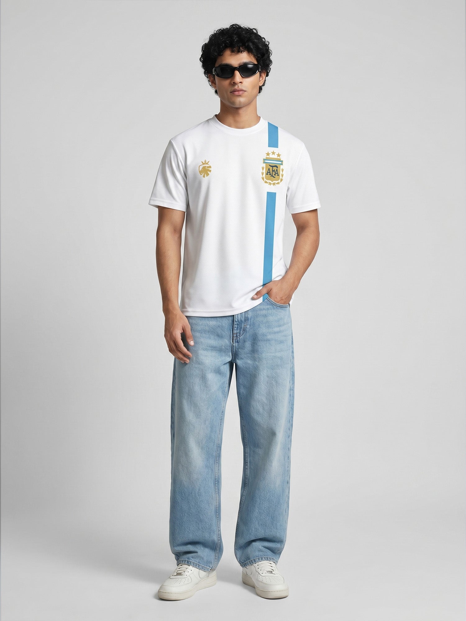 Person wearing a white t-shirt with a Argentina Messi jersey blue stripe and blue jeans on a grey background