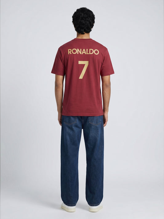 Person wearing a red sports jersey with 'RONALDO' and number '7' on the back, standing against a white background.