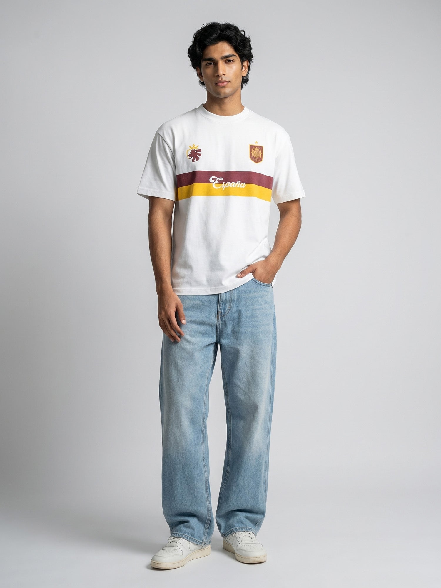 Person wearing a white t-shirt with Spanish-themed football jersey design on a grey background